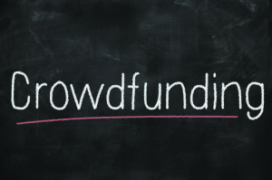Crowdfunding concept written on a blackboard with chalk