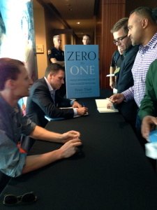 Peter Thiel signing books with Blake Masters, his co-author and former student. 