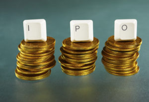 IPO letter on each block over gold coins stacks